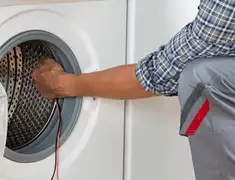 Dryer repair technician diagnosing and servicing a clothes dryer in Peoria, IL