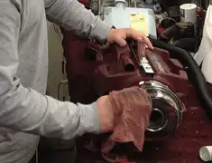 Vacuum repair technician cleaning and servicing a vacuum motor in Peoria, IL